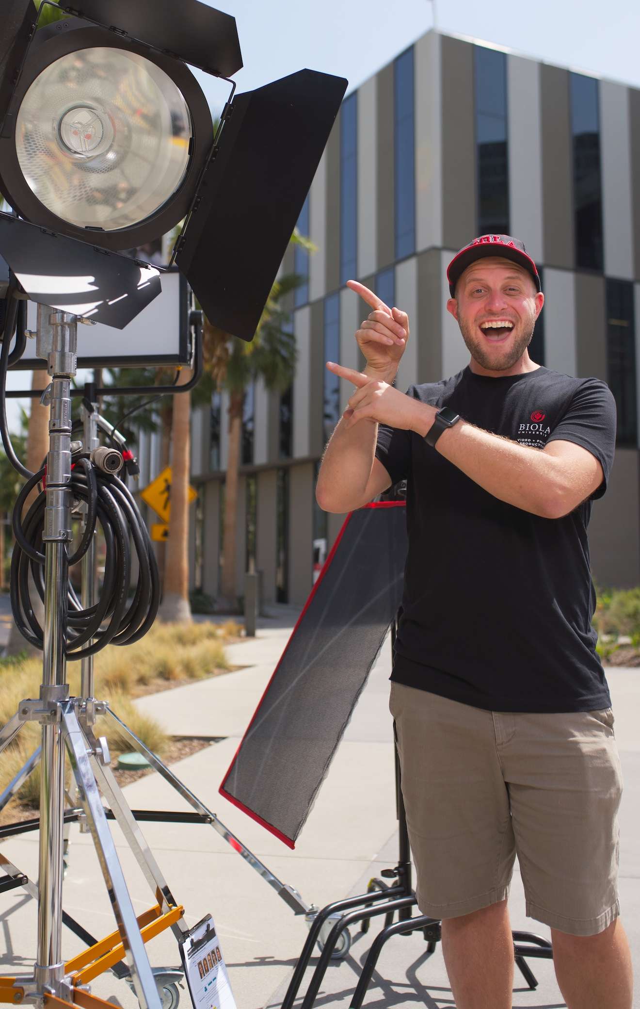 David standing next to a large Hive film light